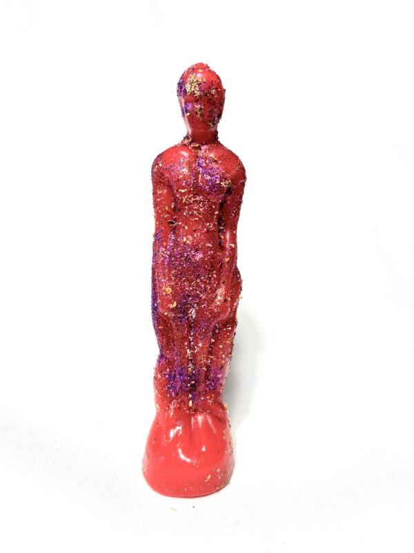 A red statue with purple and pink paint on it.