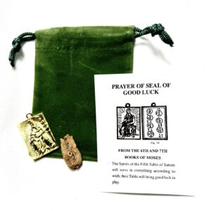 A green bag with some papers and a small gold object