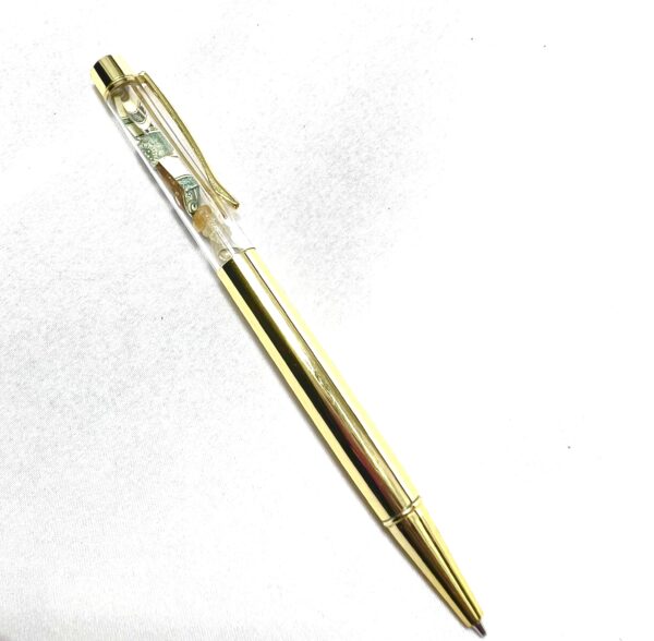 A gold pen with a clear top and white background