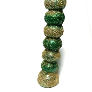 A green and gold bead tower on white background.