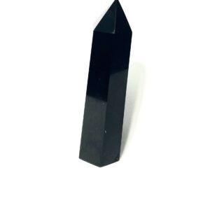 A black stone is standing up on top of the floor.