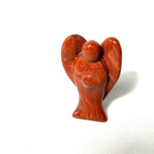 A red clay figurine of an angel with arms outstretched.