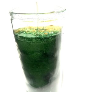 A glass of green liquid with a straw in it.