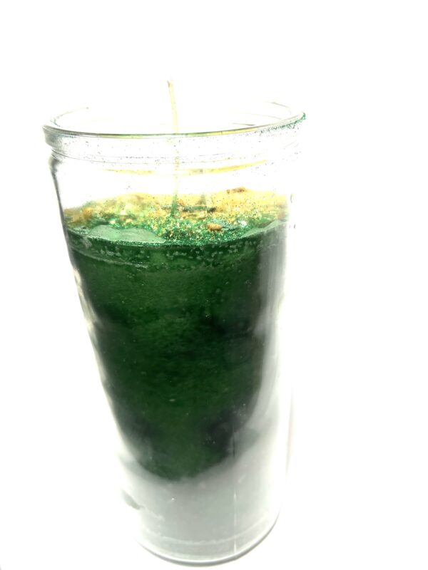 A glass of green liquid with a straw in it.