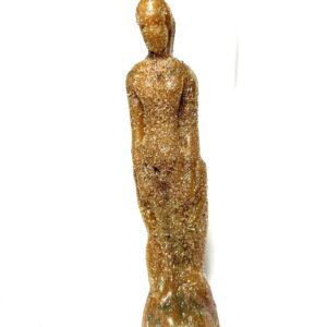 A statue of a woman in gold is standing on the ground.