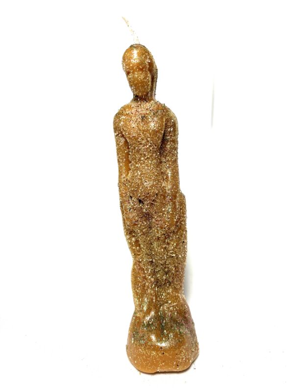 A statue of a woman in gold is standing on the ground.