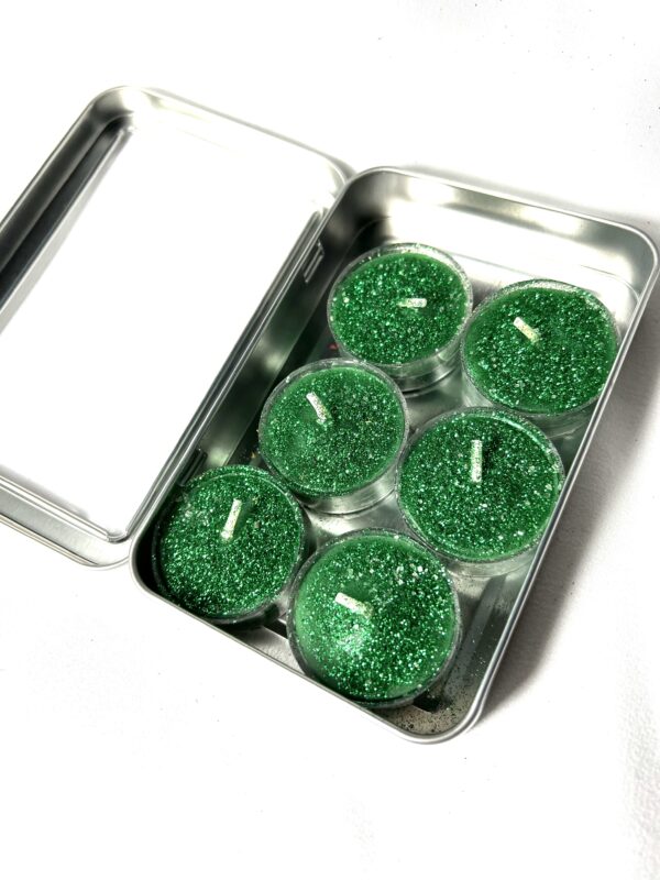 A tin of green candles in the middle of it.