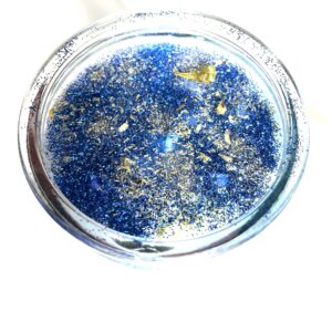 A glass bowl filled with blue and gold liquid.