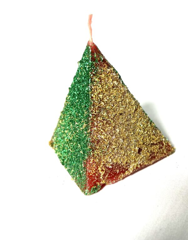 A green and red triangle ornament hanging from a string.