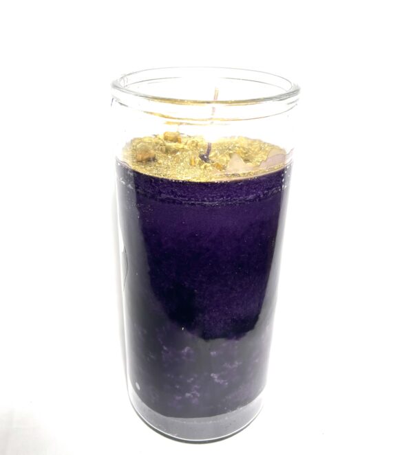 A candle in a glass with purple color.