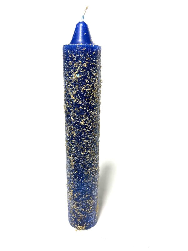 A blue candle with gold flakes on it.