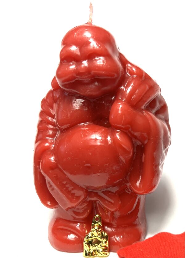 A red gorilla statue sitting on top of a table.