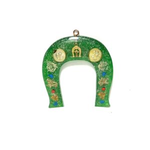 A green horseshoe with gold and clock faces.