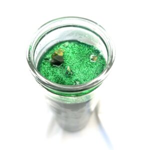 A green substance in a glass jar.