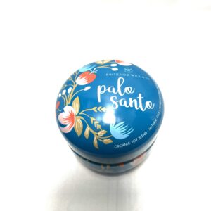 A blue tin with some type of flower design on it