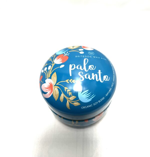 A blue tin with some type of flower design on it