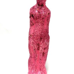 A pink sculpture of a person standing in front of a wall.