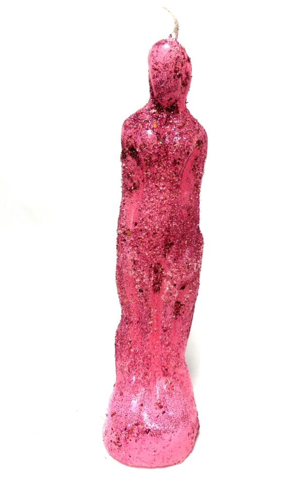 A pink sculpture of a person standing in front of a wall.