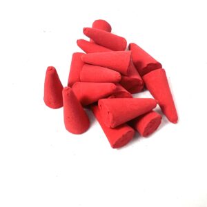 A pile of red colored wax candles on top of each other.