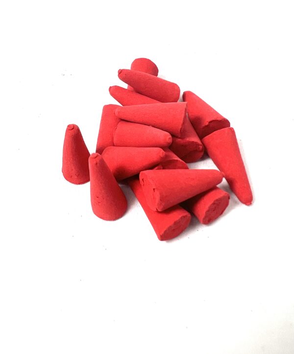 A pile of red colored wax candles on top of each other.