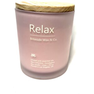 A candle that says relax on it.