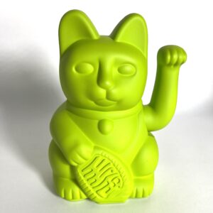 A neon green cat with a tennis racket in its paws.