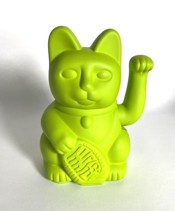 A neon green cat with a tennis racket in its paws.