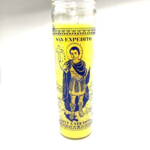 A yellow candle with an image of a man holding something.