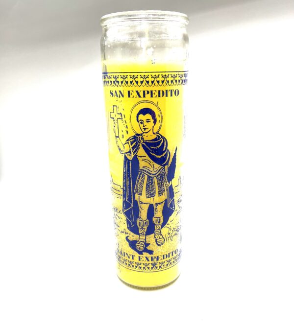 A yellow candle with an image of a man holding something.