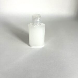 A white bottle sitting on top of a table.