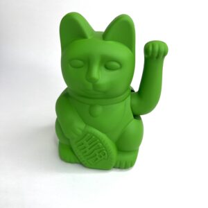 A green cat with a tennis racket in its mouth.