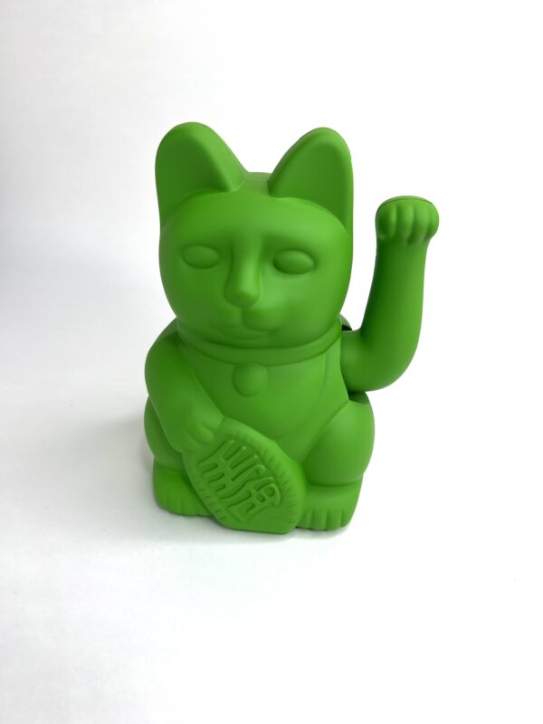 A green cat with a tennis racket in its mouth.