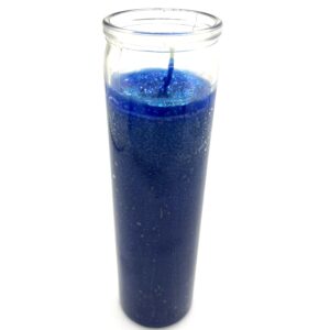 A candle in a glass with blue wax.