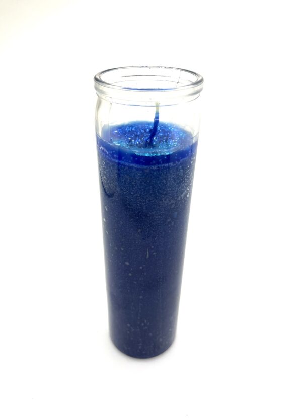 A candle in a glass with blue wax.