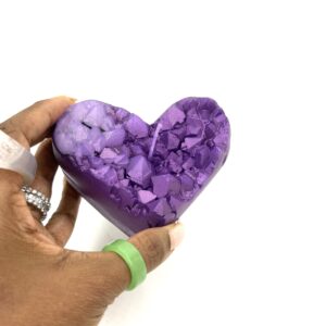 A person holding a purple heart in their hand.