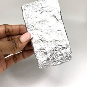 A person holding onto some foil