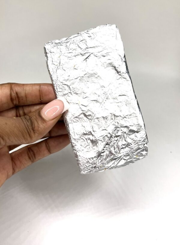 A person holding onto some foil