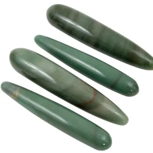 A group of four green stones sitting next to each other.