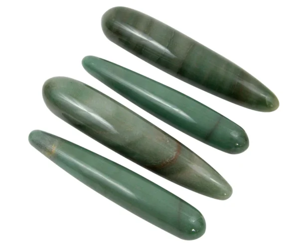 A group of four green stones sitting next to each other.