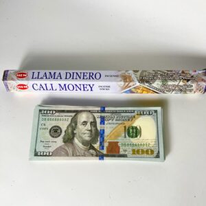 A roll of money and a box with the words " llama dinero call money trip ".