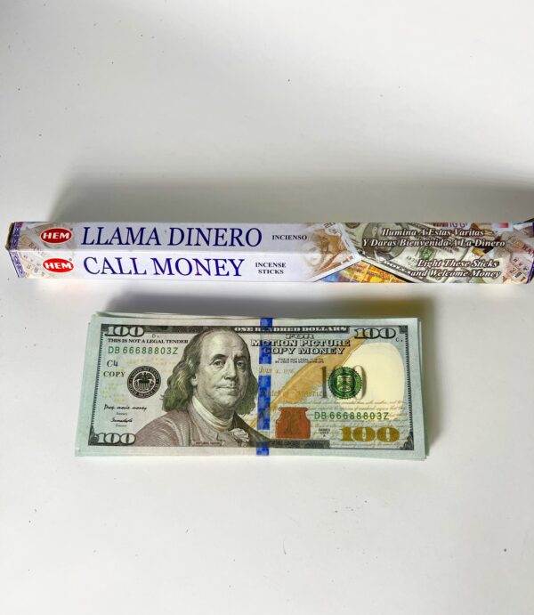 A roll of money and a box with the words " llama dinero call money trip ".