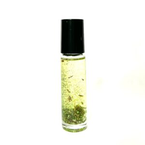 A bottle of oil with some green stuff in it