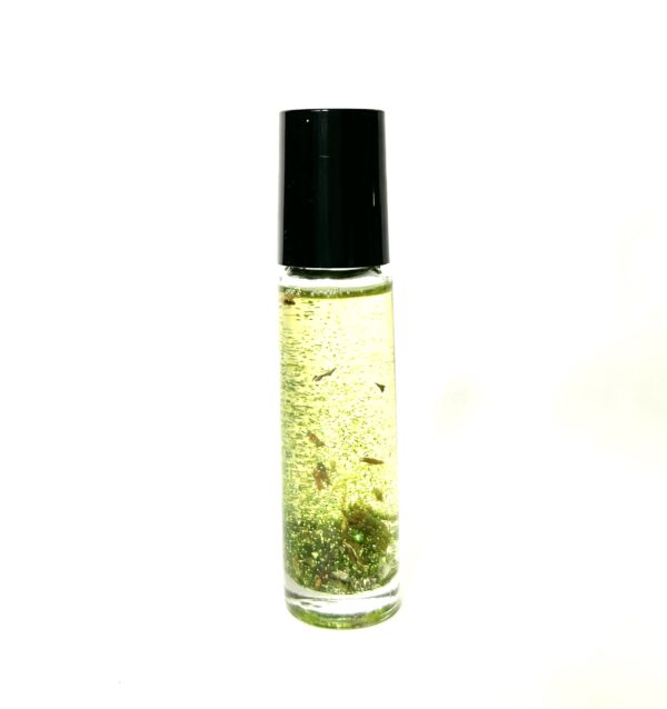 A bottle of oil with some green stuff in it