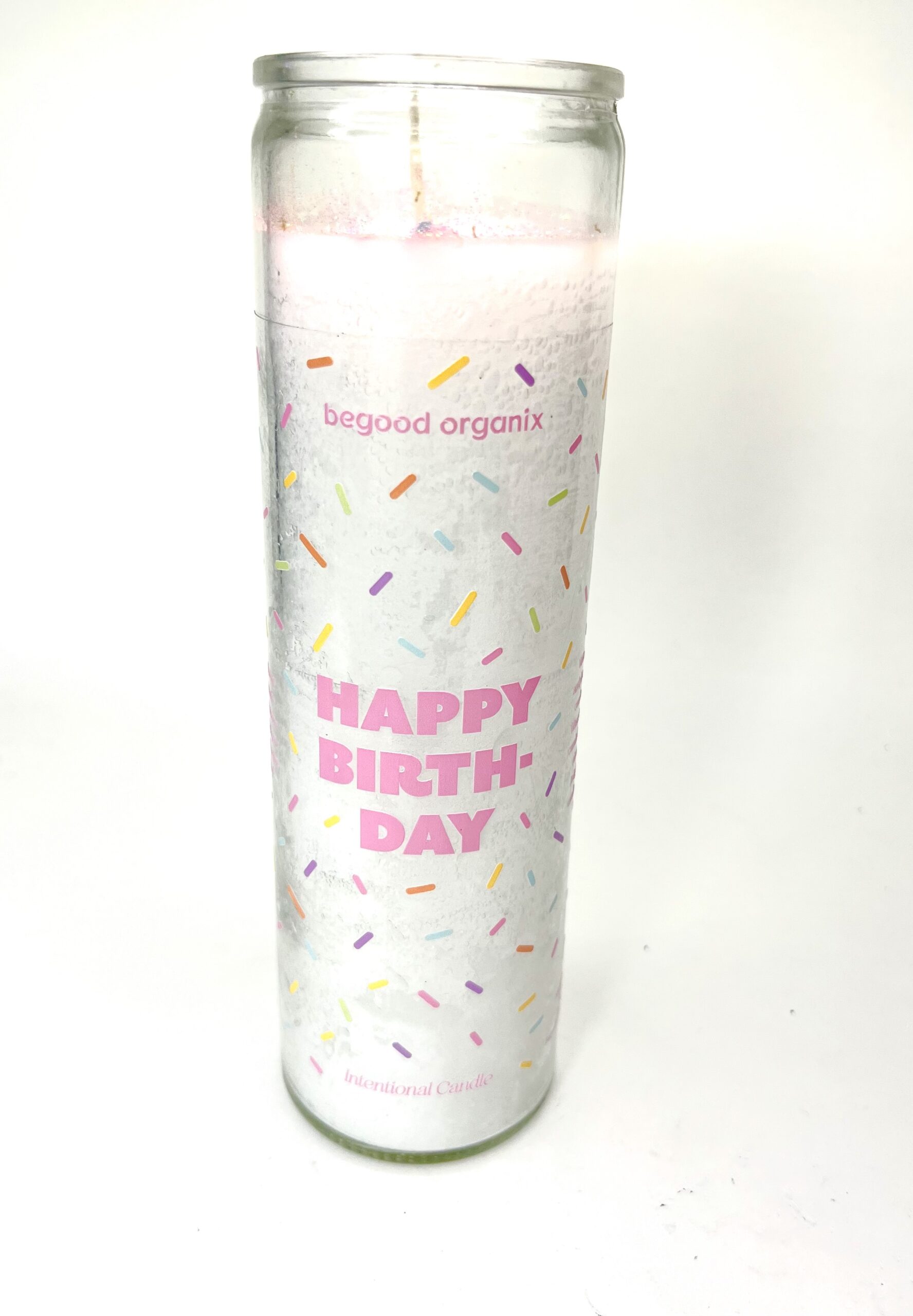 A candle that says happy birthday with sprinkles.