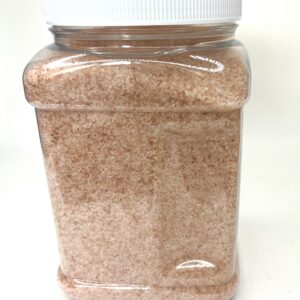 A large container of brown sand with white lid.