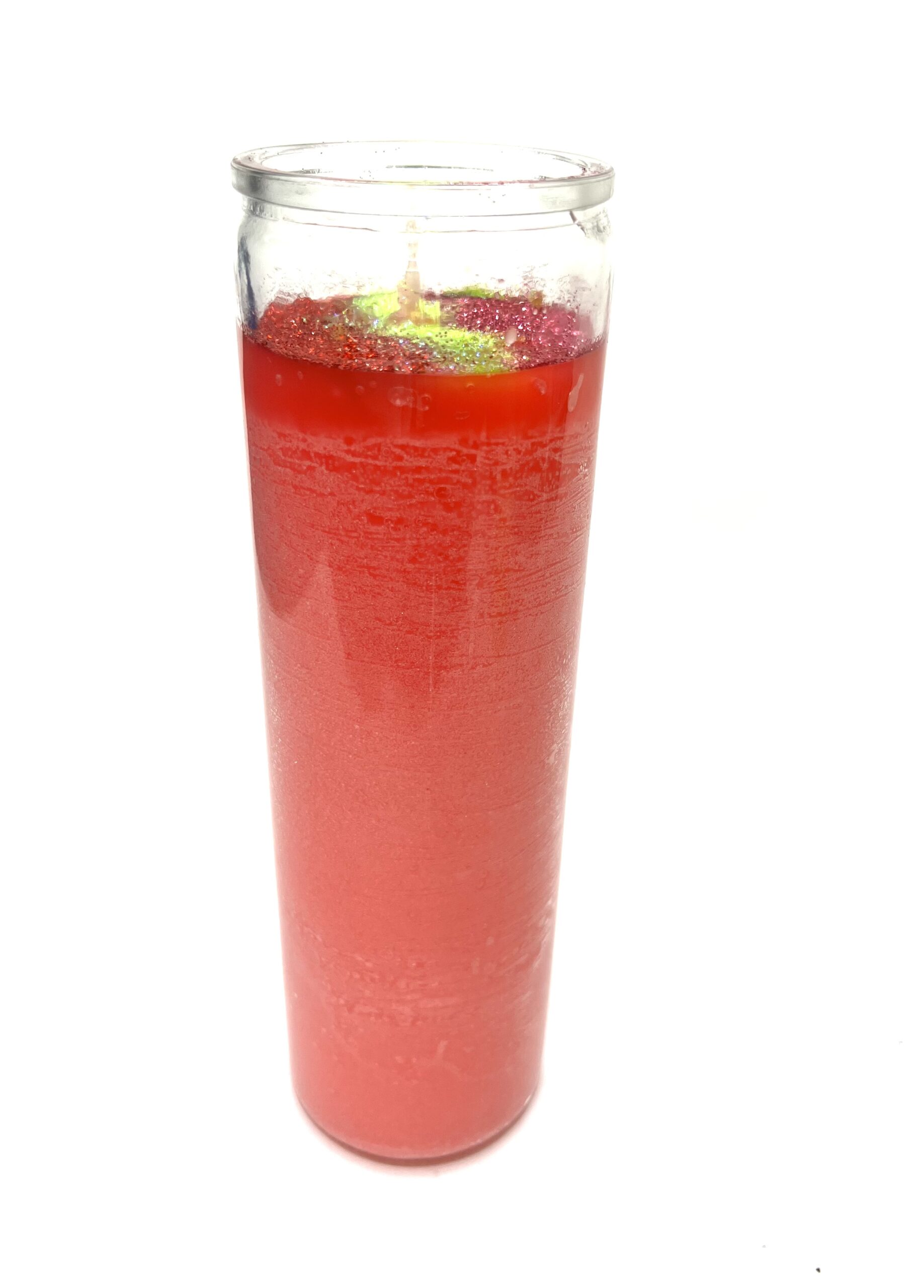 A glass of red liquid with lime on top.