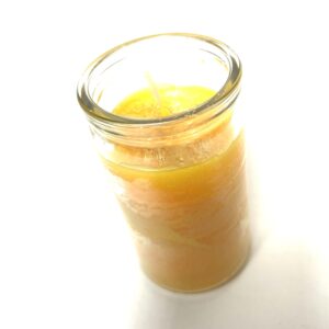 A jar of orange juice on top of a table.