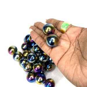 A hand holding a bunch of colorful balls