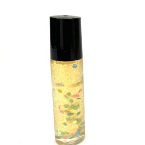 A bottle of perfume with colorful sprinkles on it.