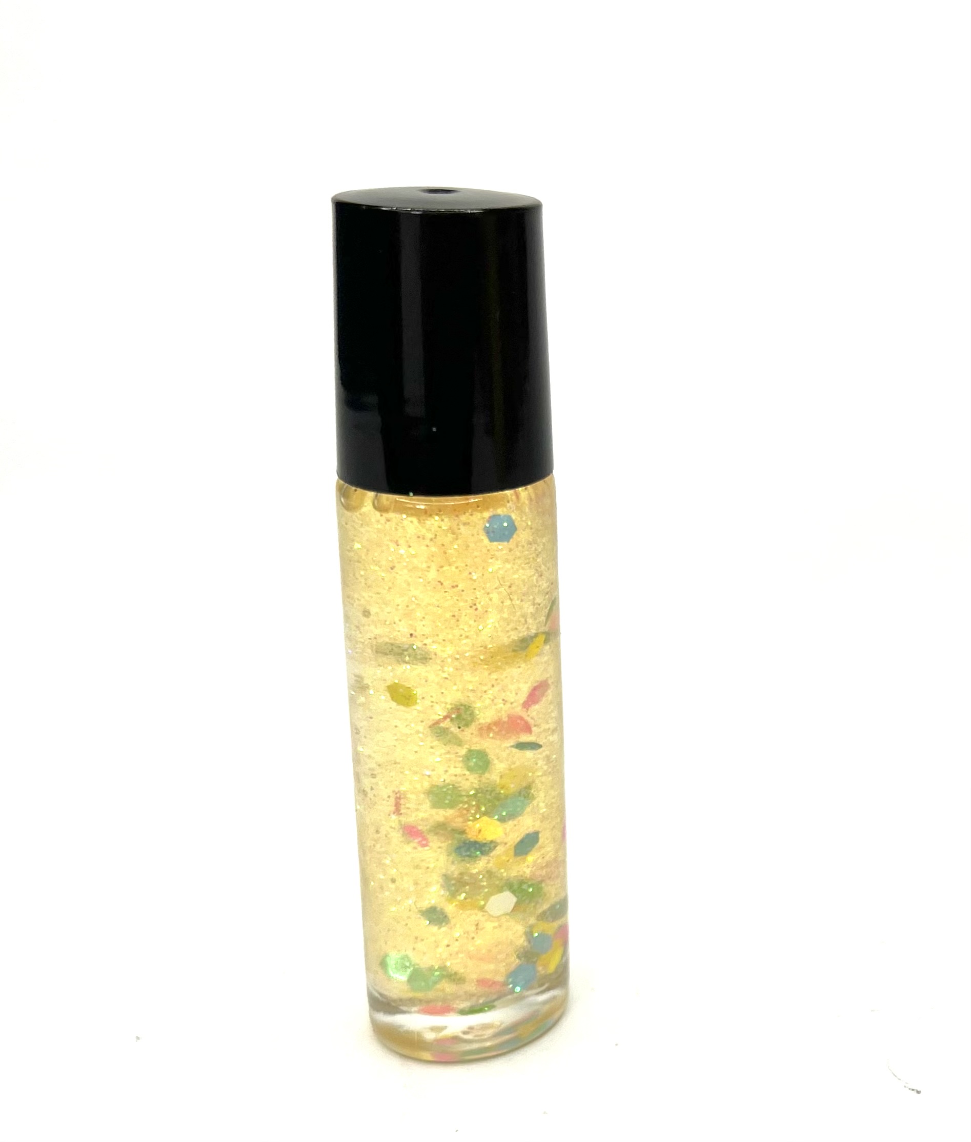 A bottle of perfume with colorful sprinkles on it.